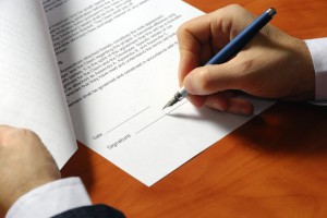 contract signing close up of hand and pen